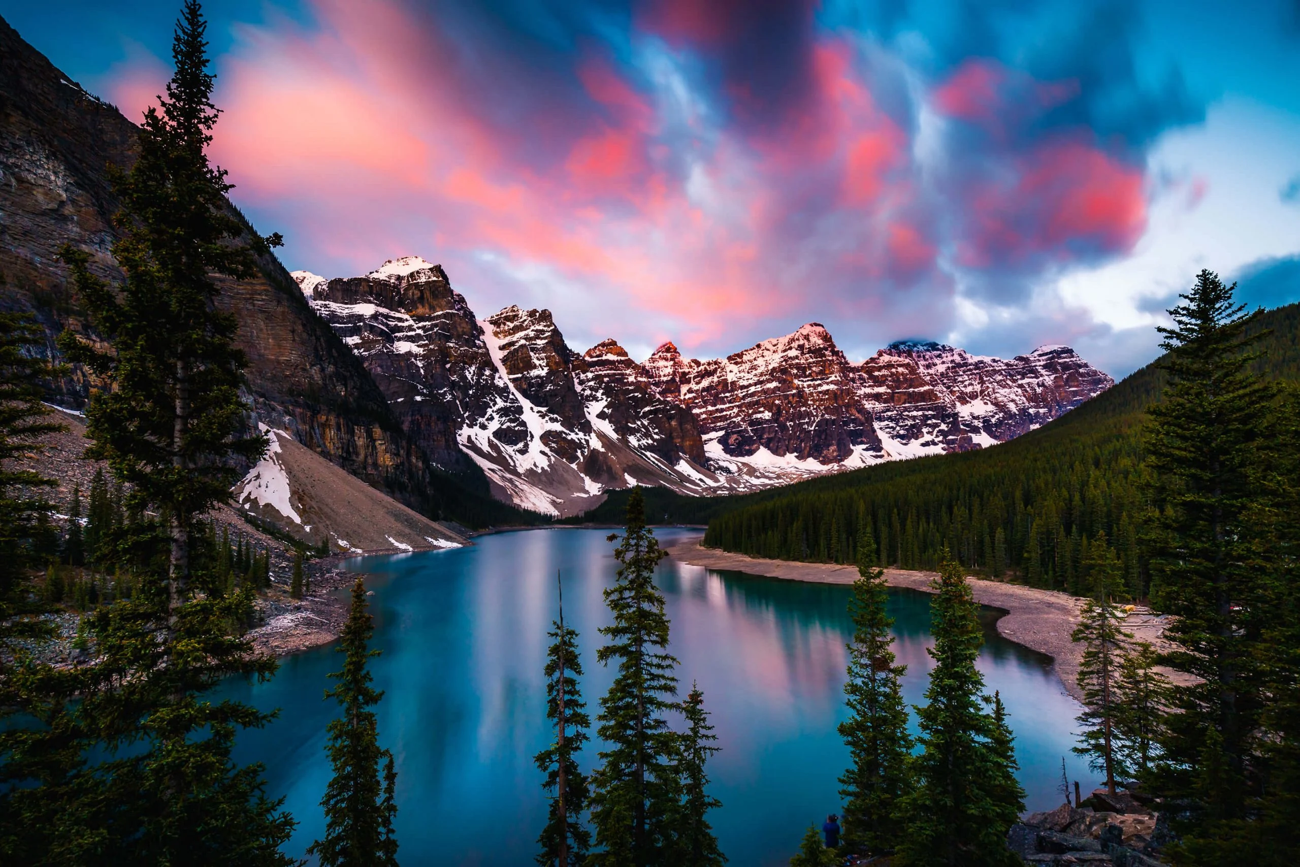 Mountain lake at dawn beneath snow-covered peaks