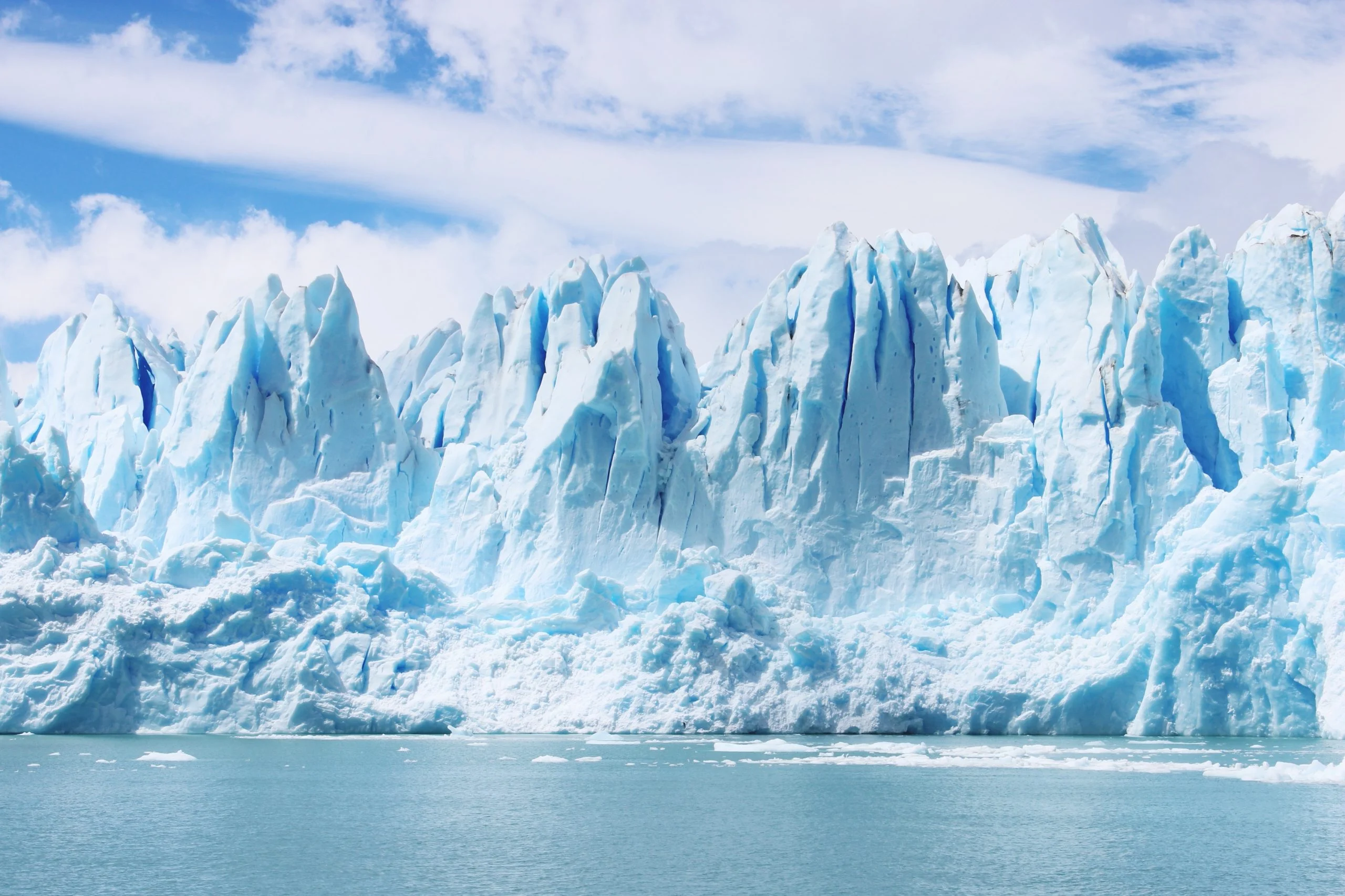 Towering glacier front meeting still water
