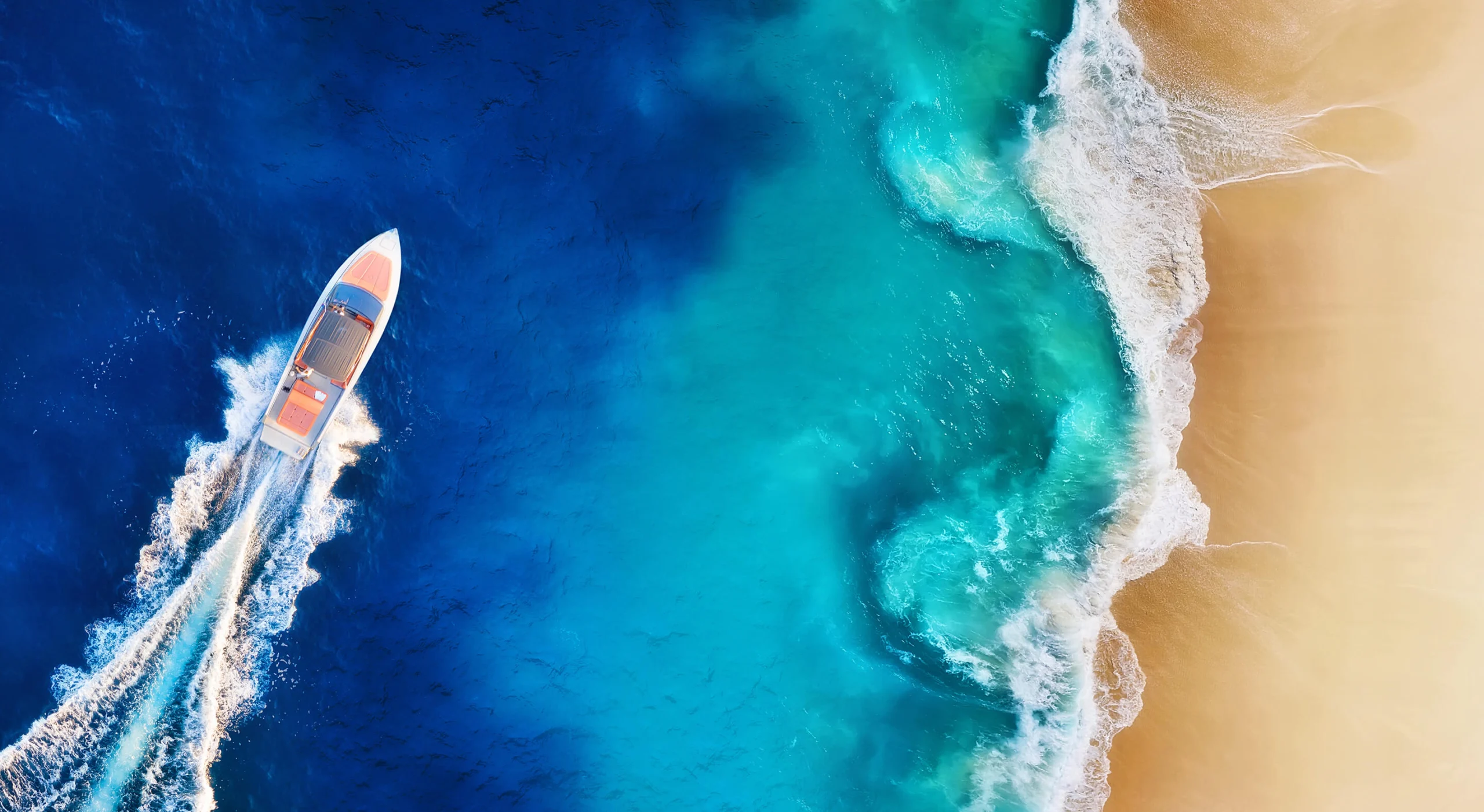 Boat cutting across deep blue water