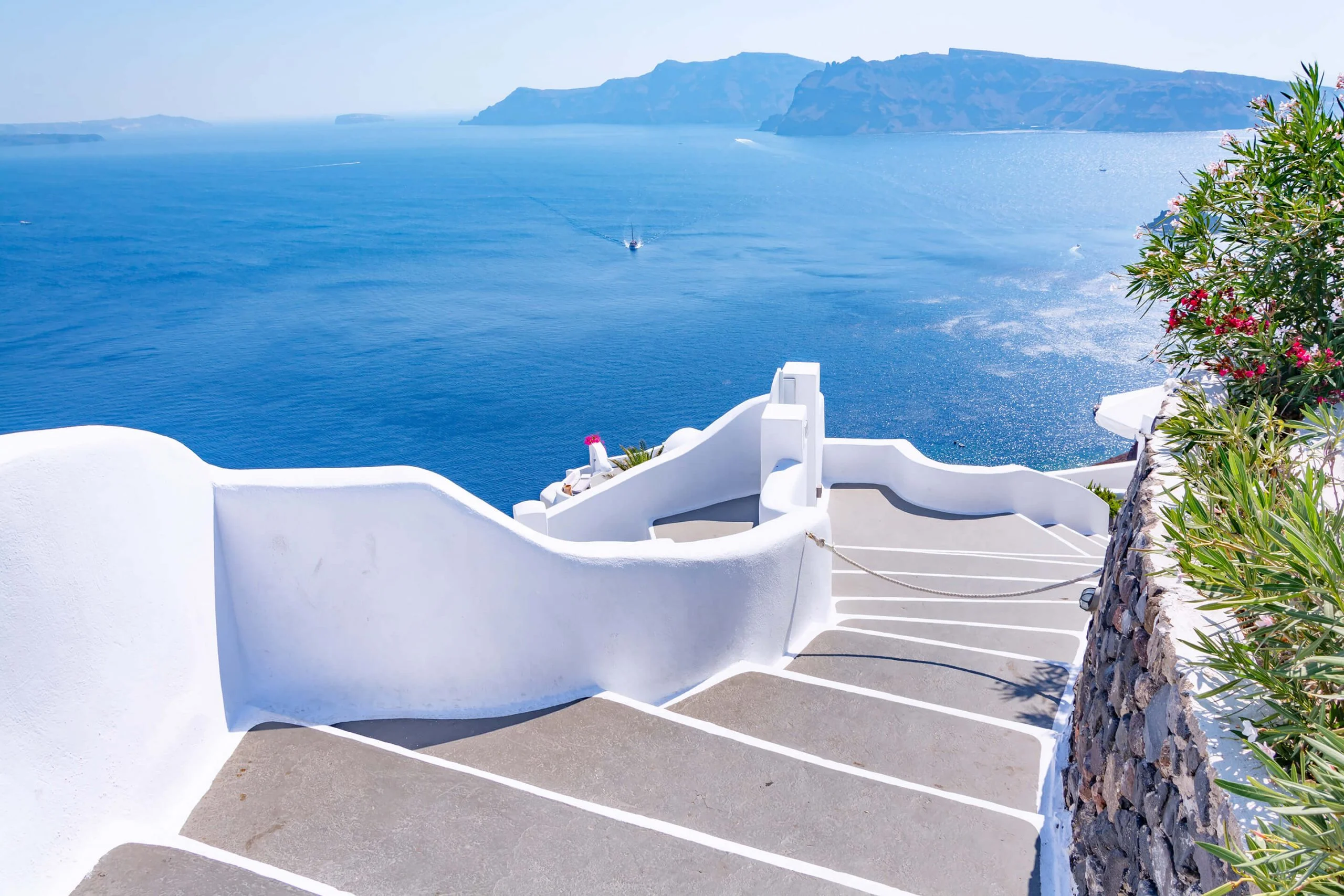 White steps descending toward the blue sea