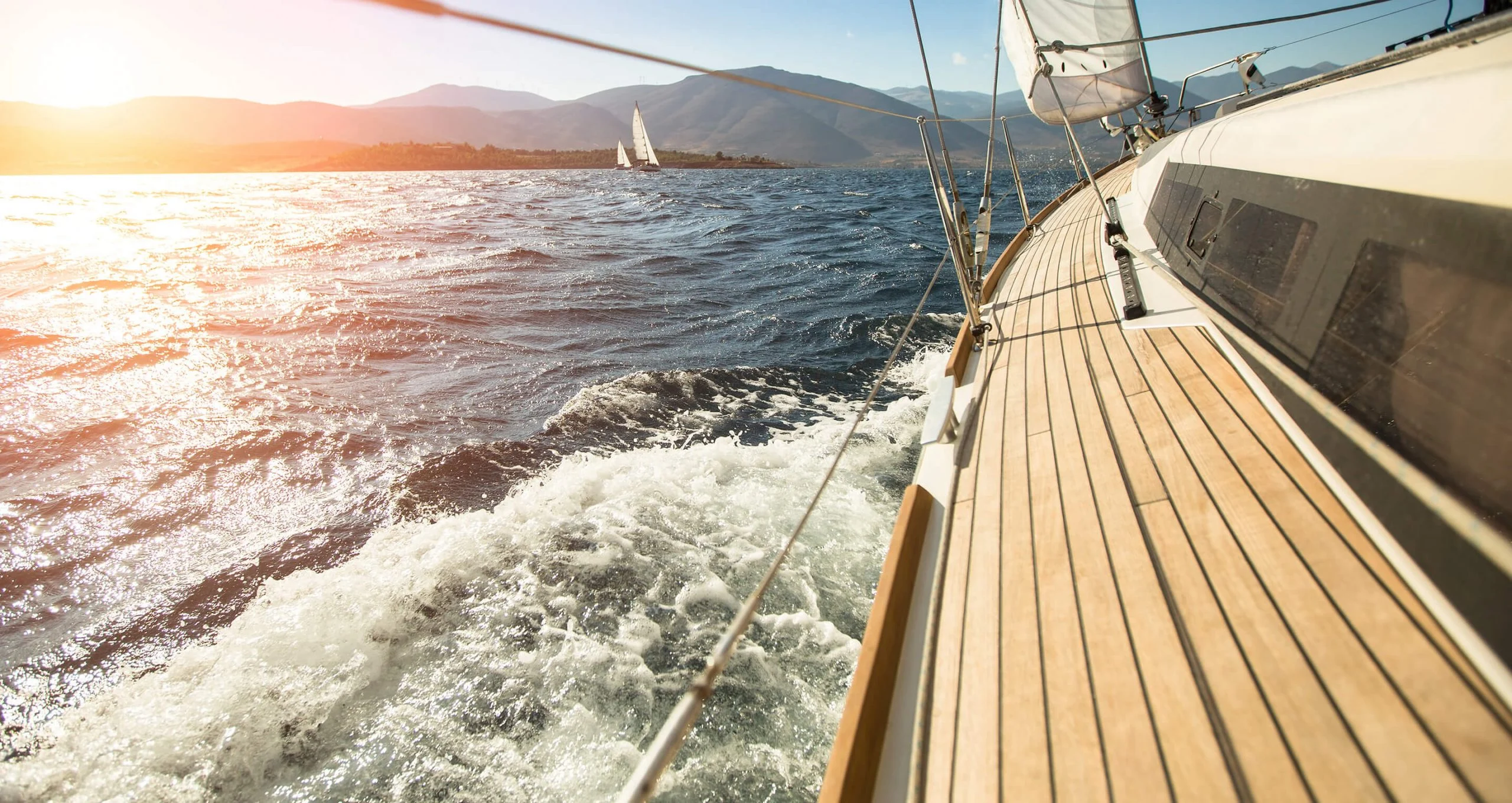 Deck of a sailing yacht cutting through open water