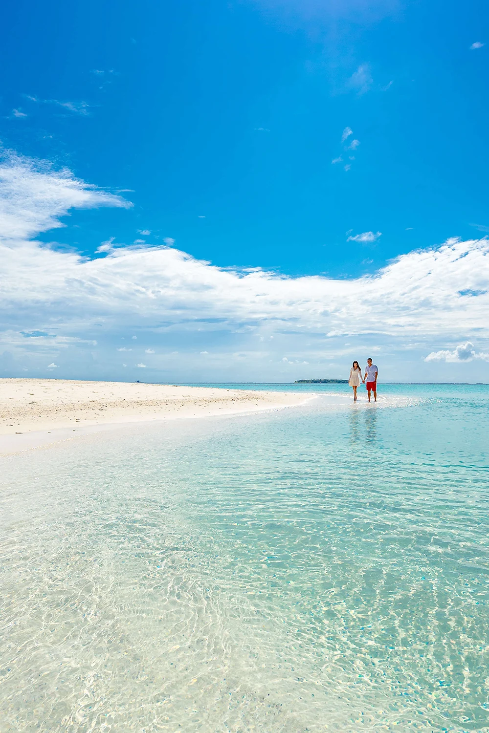 Couple walking a sandbar in Fiji