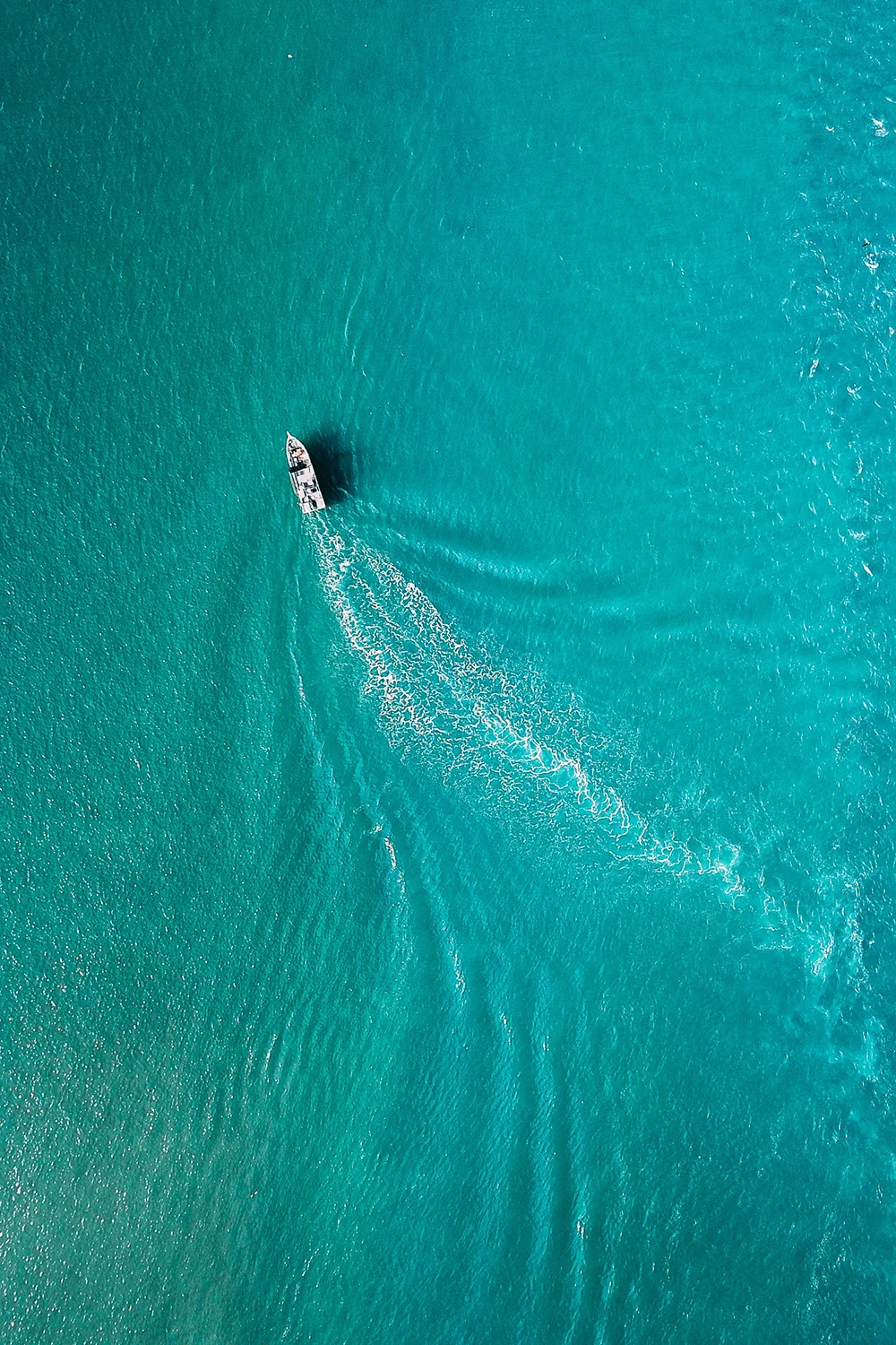 Boat crossing turquoise water